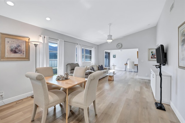 dining room featuring lofted ceiling, light hardwood / wood-style flooring, and ceiling fan