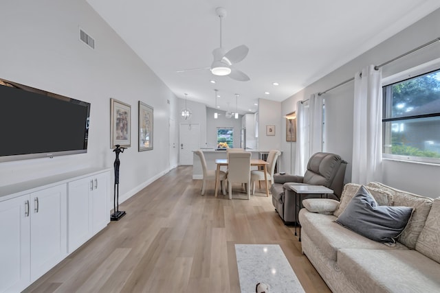 living room featuring vaulted ceiling, light wood-type flooring, and ceiling fan