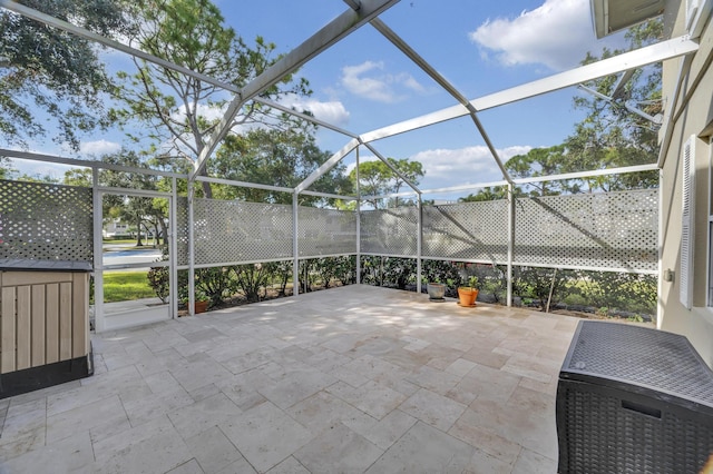 view of patio with glass enclosure