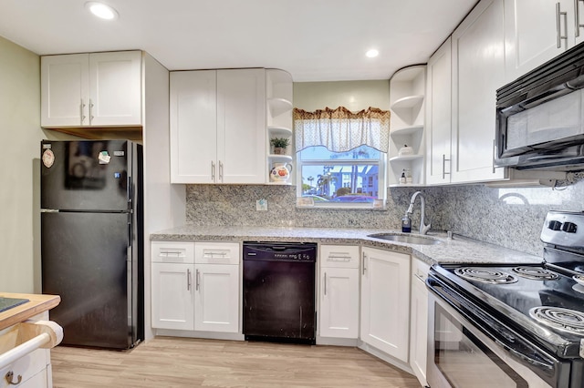 kitchen with sink, light hardwood / wood-style flooring, black appliances, and white cabinets