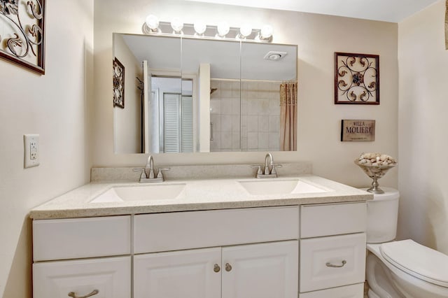 bathroom featuring vanity, walk in shower, and toilet