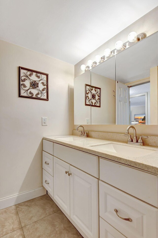 bathroom featuring tile patterned flooring and vanity