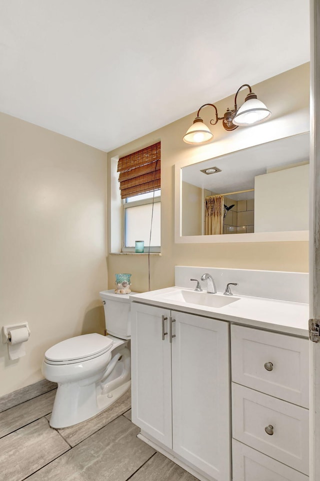 bathroom featuring vanity, a shower with curtain, and toilet