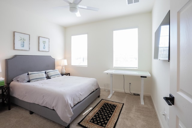 bedroom with ceiling fan and light carpet