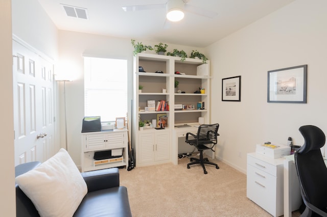 carpeted office with ceiling fan