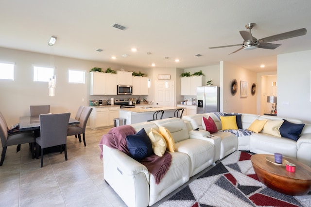 living room with sink and light tile patterned floors