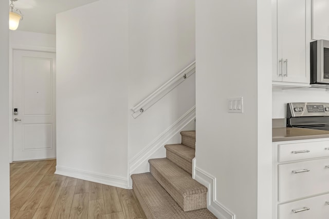 stairway with hardwood / wood-style flooring