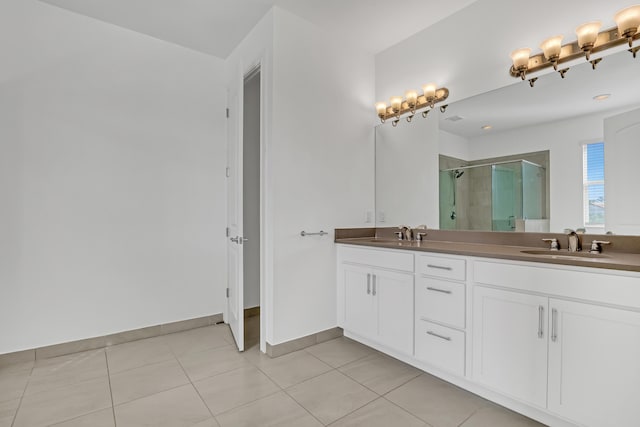 bathroom featuring tile patterned flooring, vanity, and walk in shower