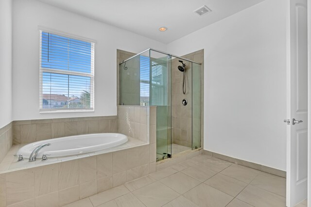 bathroom featuring separate shower and tub and tile patterned flooring