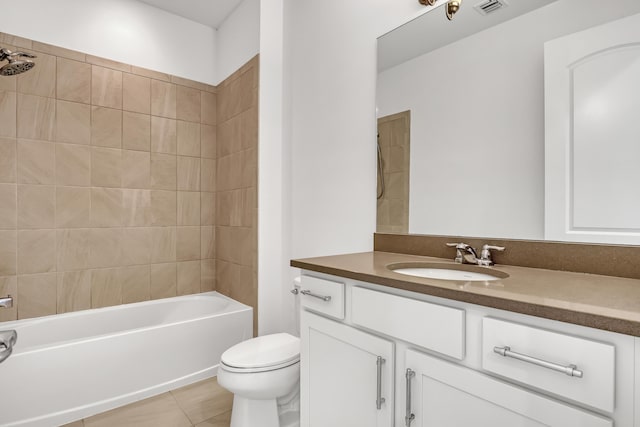 full bathroom with vanity, tiled shower / bath combo, tile patterned floors, and toilet