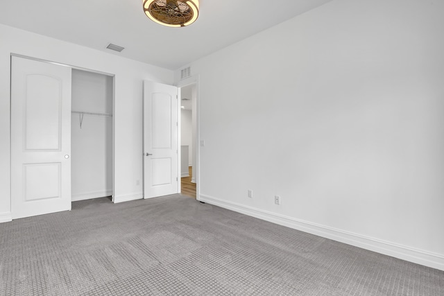 unfurnished bedroom featuring carpet floors and a closet