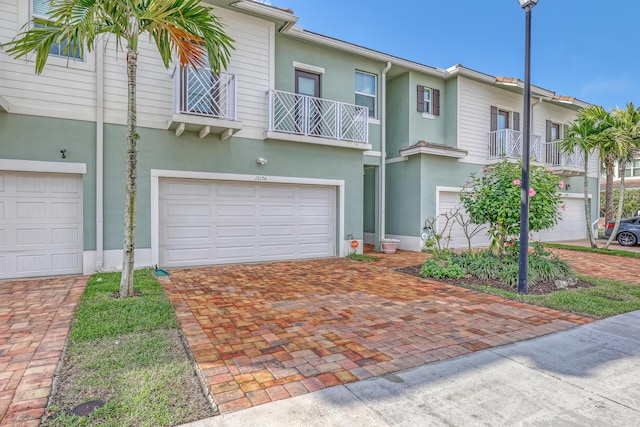 view of property with a garage and a balcony