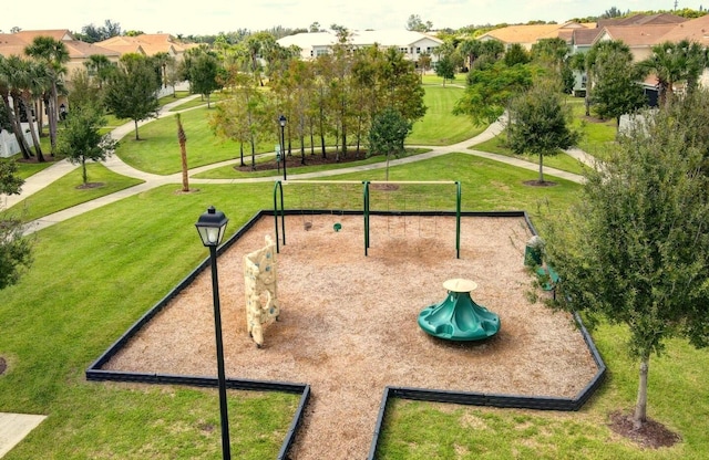 view of property's community with a playground and a lawn