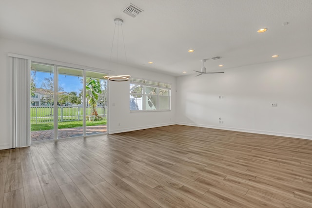 spare room with ceiling fan and light wood-type flooring