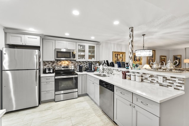 kitchen with gray cabinetry, sink, and stainless steel appliances