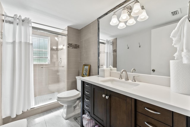 bathroom with vanity, toilet, and a shower with shower door