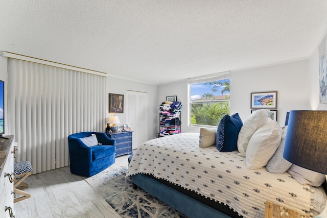 bedroom with crown molding and a textured ceiling