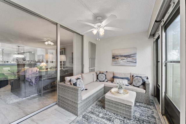 living room featuring a textured ceiling and ceiling fan