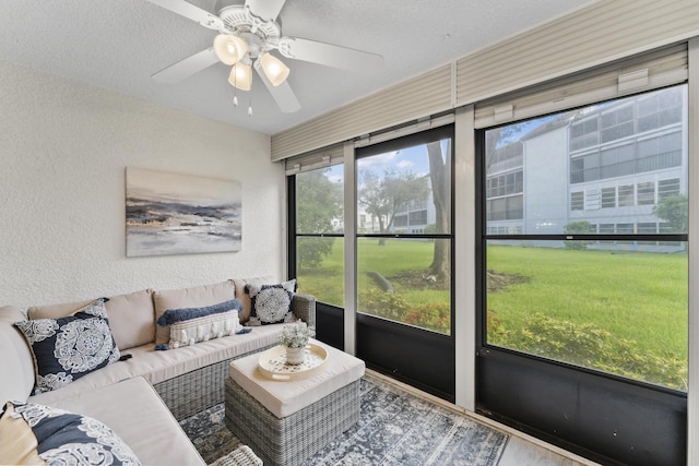 sunroom / solarium featuring ceiling fan