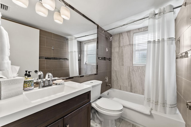 full bathroom featuring shower / bath combination with curtain, vanity, toilet, and tile walls