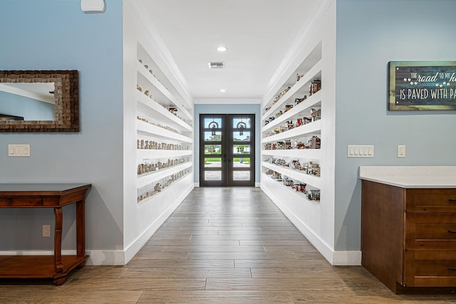 11951 Torreyanna Cir, Palm Beach Gardens, FL 33412 - interior space featuring built in features, french doors, ornamental molding, light wood-type flooring, and baseboards