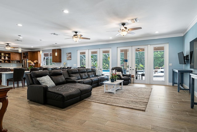 11951 Torreyanna Cir, Palm Beach Gardens, FL 33412 - living room featuring light wood-type flooring, plenty of natural light, visible vents, and french doors