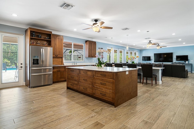 11951 Torreyanna Cir, Palm Beach Gardens, FL 33412 - kitchen featuring stainless steel fridge, a center island, hanging light fixtures, light countertops, and open shelves