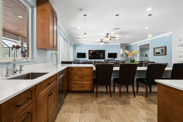 11951 Torreyanna Cir, Palm Beach Gardens, FL 33412 - kitchen with a sink, open floor plan, light countertops, stainless steel dishwasher, and decorative light fixtures