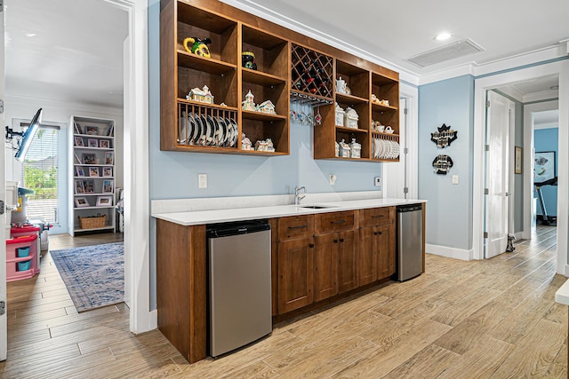 11951 Torreyanna Cir, Palm Beach Gardens, FL 33412 - bar with light wood-style floors, a sink, visible vents, and crown molding