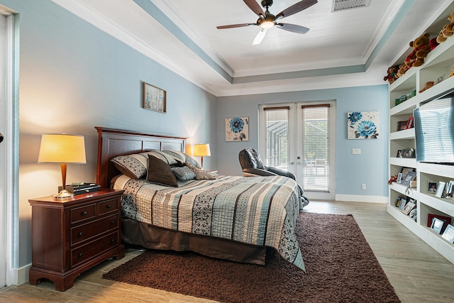 11951 Torreyanna Cir, Palm Beach Gardens, FL 33412 - bedroom with light wood finished floors, visible vents, access to outside, a tray ceiling, and french doors