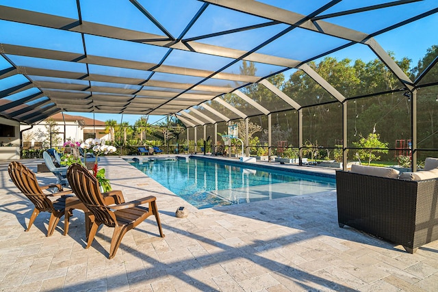 pool with glass enclosure and a patio