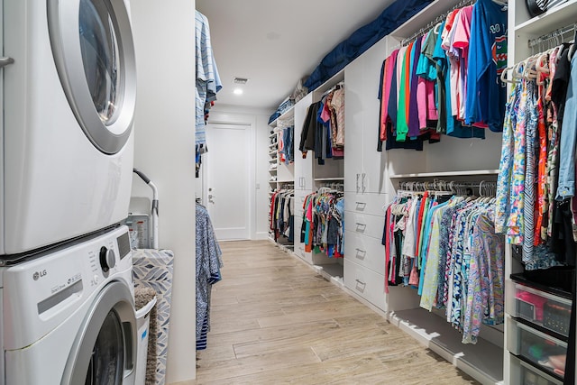 11951 Torreyanna Cir, Palm Beach Gardens, FL 33412 - interior space with light wood-style floors, laundry area, visible vents, and stacked washing maching and dryer