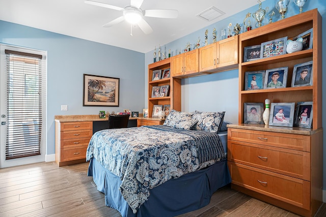 11951 Torreyanna Cir, Palm Beach Gardens, FL 33412 - bedroom with baseboards, visible vents, ceiling fan, and wood finished floors