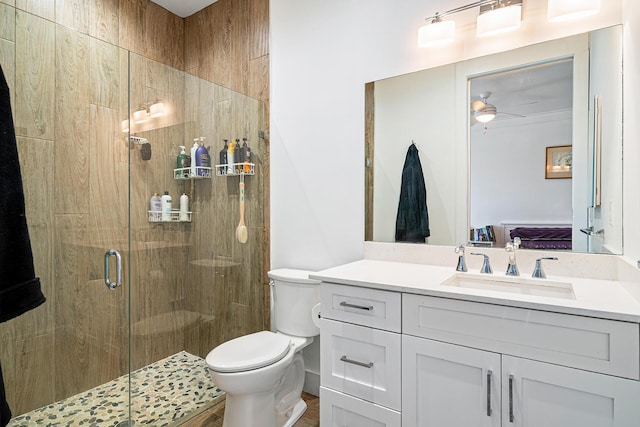 11951 Torreyanna Cir, Palm Beach Gardens, FL 33412 - ensuite bathroom with a ceiling fan, toilet, ensuite bathroom, vanity, and a shower stall