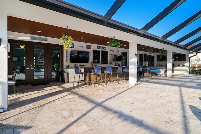 11951 Torreyanna Cir, Palm Beach Gardens, FL 33412 - view of patio / terrace featuring french doors and exterior bar