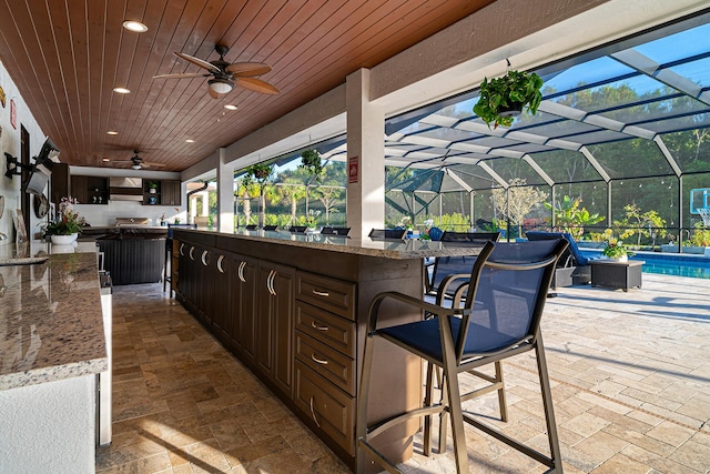 11951 Torreyanna Cir, Palm Beach Gardens, FL 33412 - view of patio with a lanai, a ceiling fan, an outdoor pool, and an outdoor bar