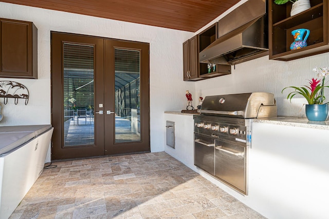 11951 Torreyanna Cir, Palm Beach Gardens, FL 33412 - kitchen with french doors, open shelves, light countertops, stone finish flooring, and wall chimney exhaust hood