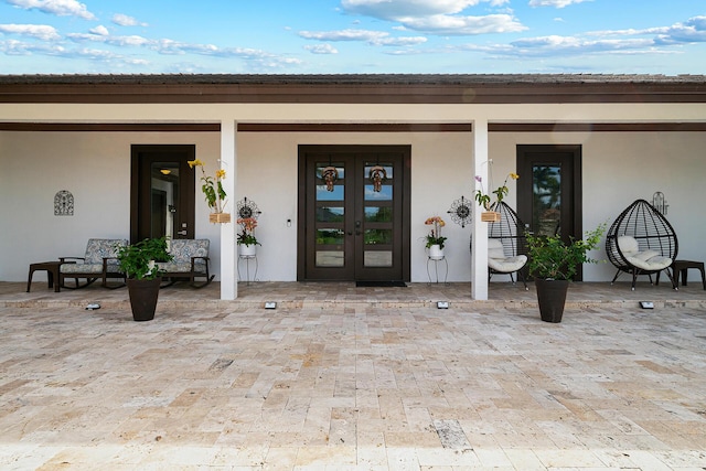 11951 Torreyanna Cir, Palm Beach Gardens, FL 33412 - doorway to property featuring french doors and stucco siding