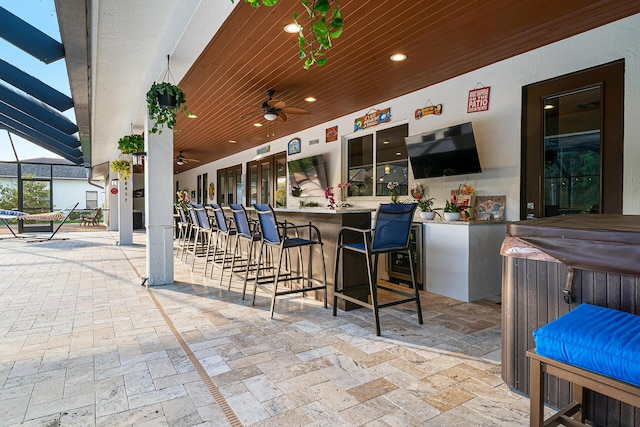 11951 Torreyanna Cir, Palm Beach Gardens, FL 33412 - view of patio with a bar, glass enclosure, a hot tub, and a ceiling fan