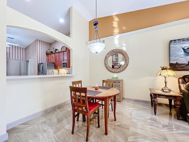 dining room featuring high vaulted ceiling