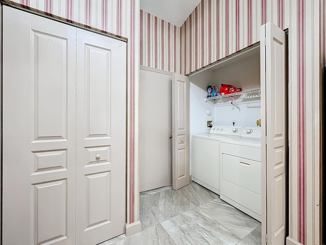 clothes washing area featuring independent washer and dryer