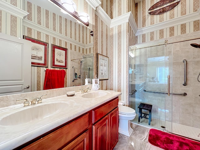 bathroom featuring a shower with door, vanity, and toilet