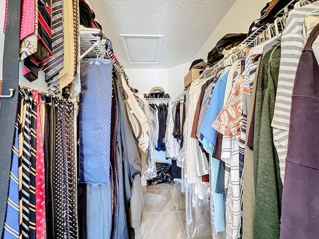 walk in closet with tile patterned floors