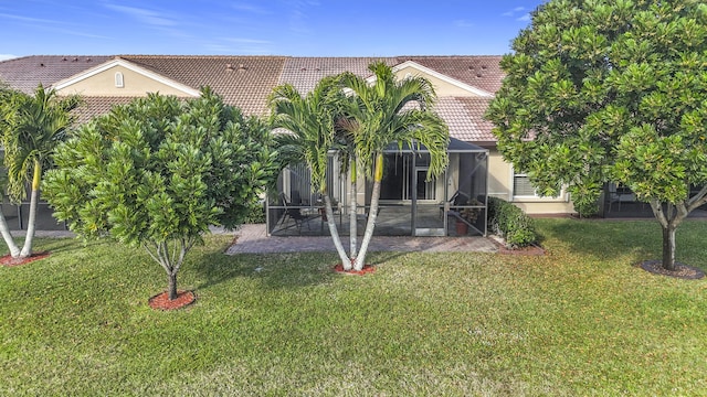 rear view of property with a patio area and a lawn