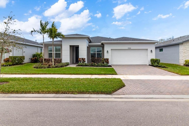 view of front facade with a garage and a front lawn