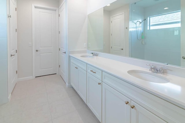 bathroom with tile patterned flooring, vanity, and walk in shower