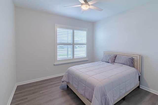 bedroom featuring dark hardwood / wood-style flooring and ceiling fan