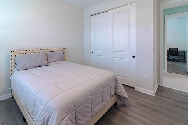 bedroom featuring dark hardwood / wood-style floors and a closet