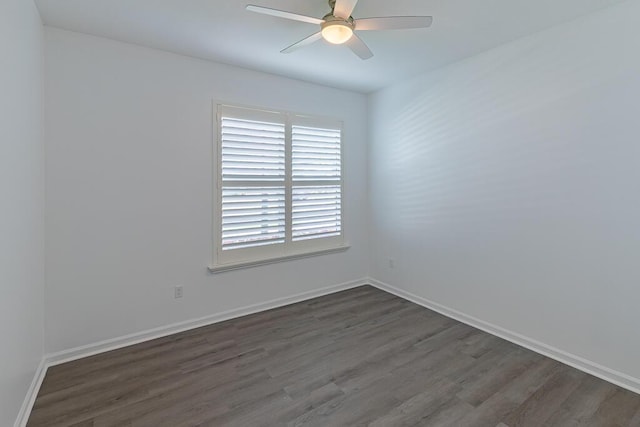 empty room with dark hardwood / wood-style floors and ceiling fan