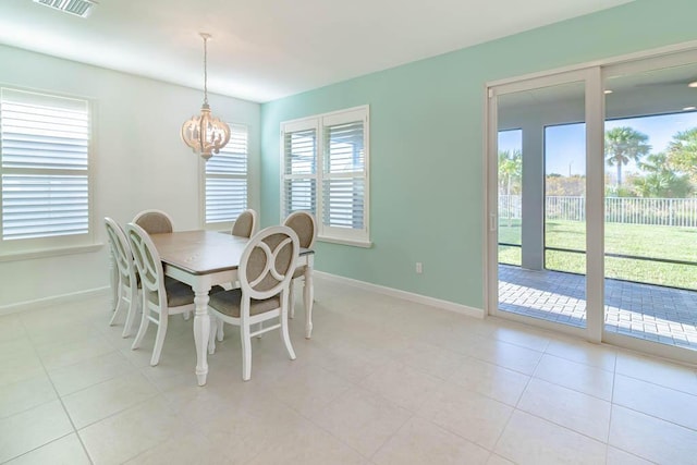 dining room with an inviting chandelier and light tile patterned floors